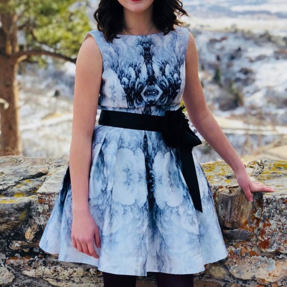 Beautiful mini dress. White background with black and grey flowers.